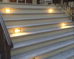 Illuminate your stairs with warm LED lights for safety and aesthetic appeal for Hilton Head outdoor settings. Custom outdoor lighting solutions for the Hilton Head area with LED stair lights enhancing safety for elevated on porch areas.
